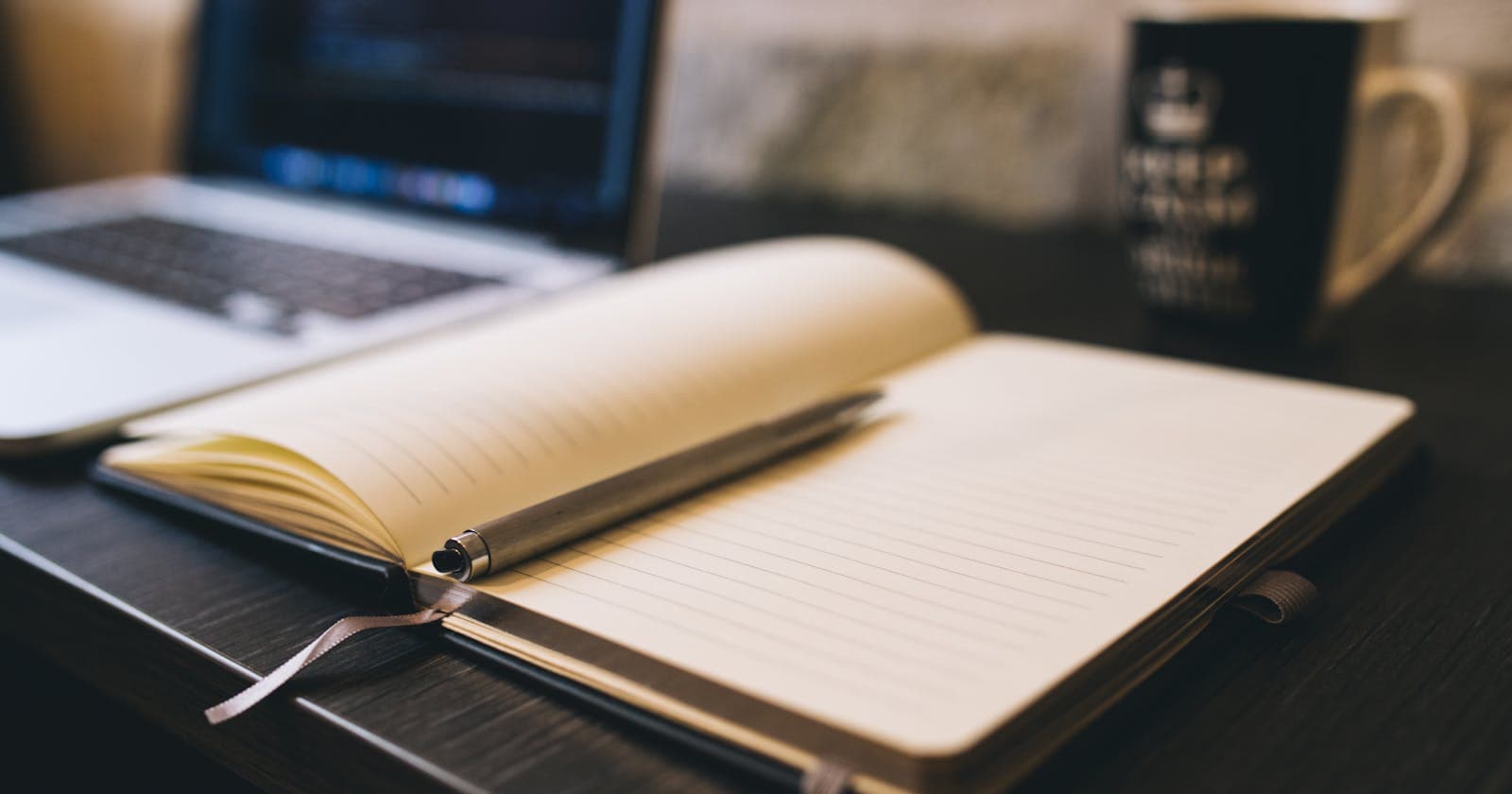 Open notebook and laptop on a desk
