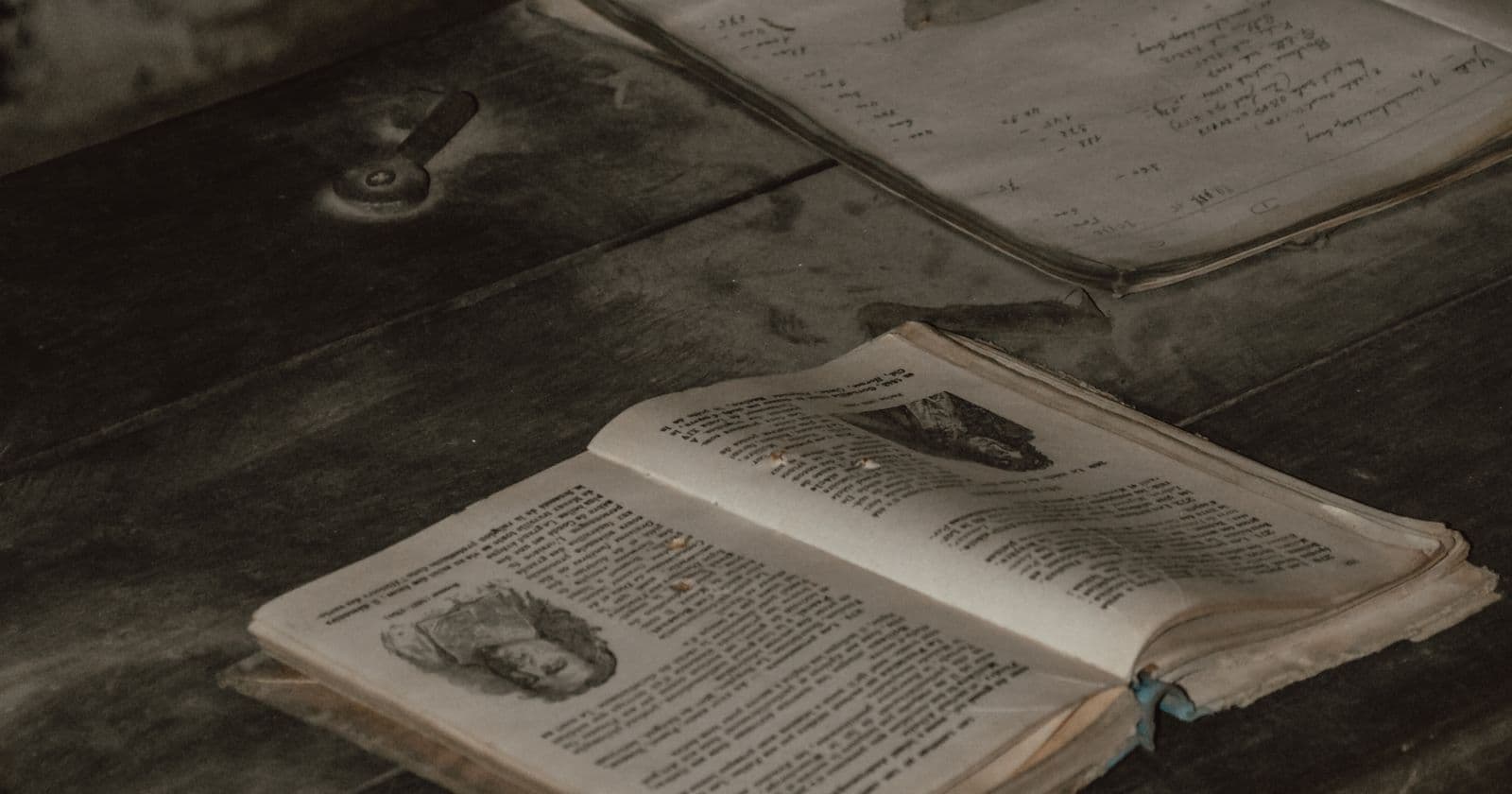 Open vintage books on a wooden surface