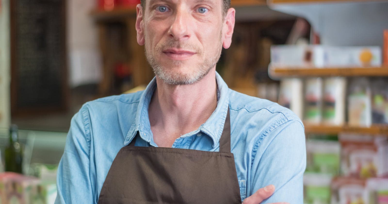 Small business shop owner standing with arms crossed