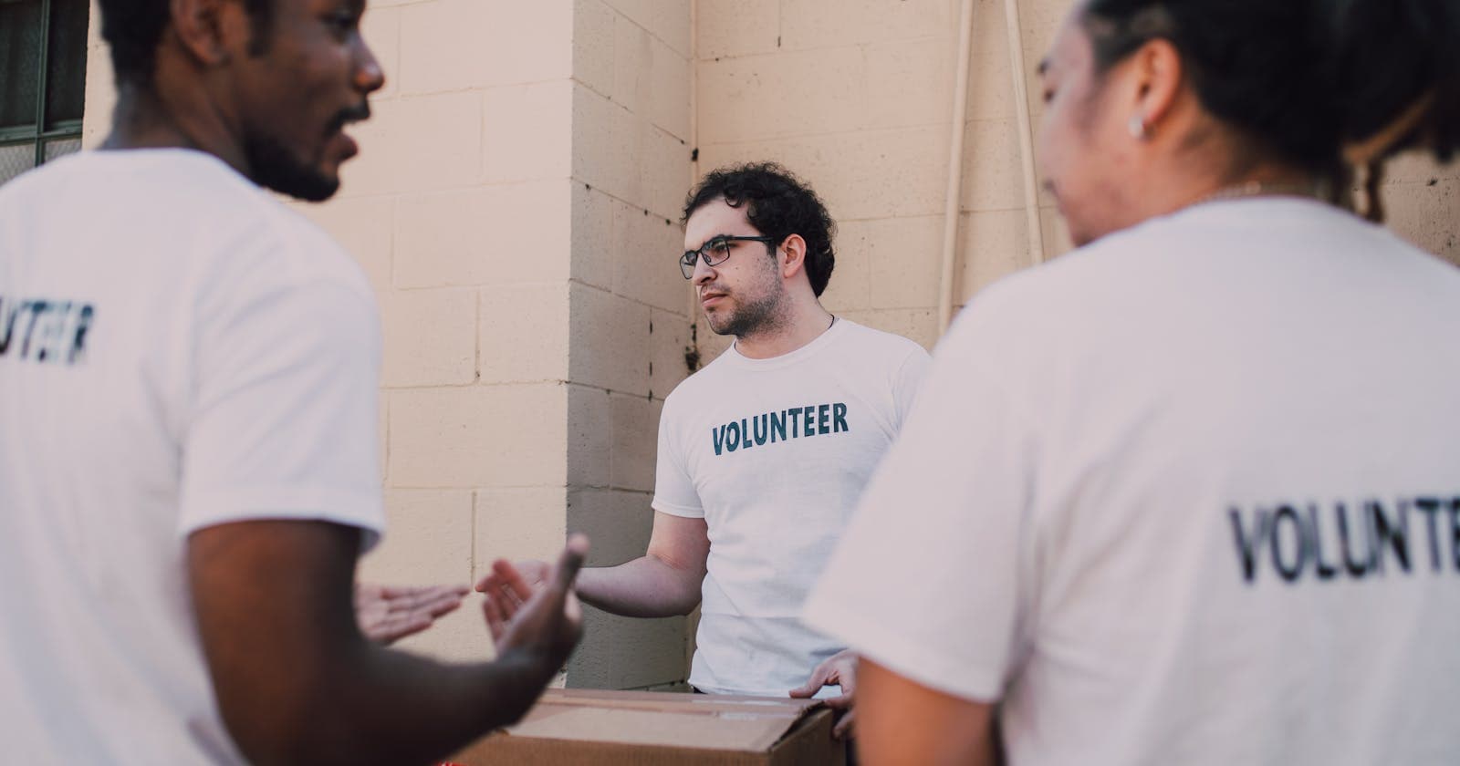 Volunteers in matching shirts working together