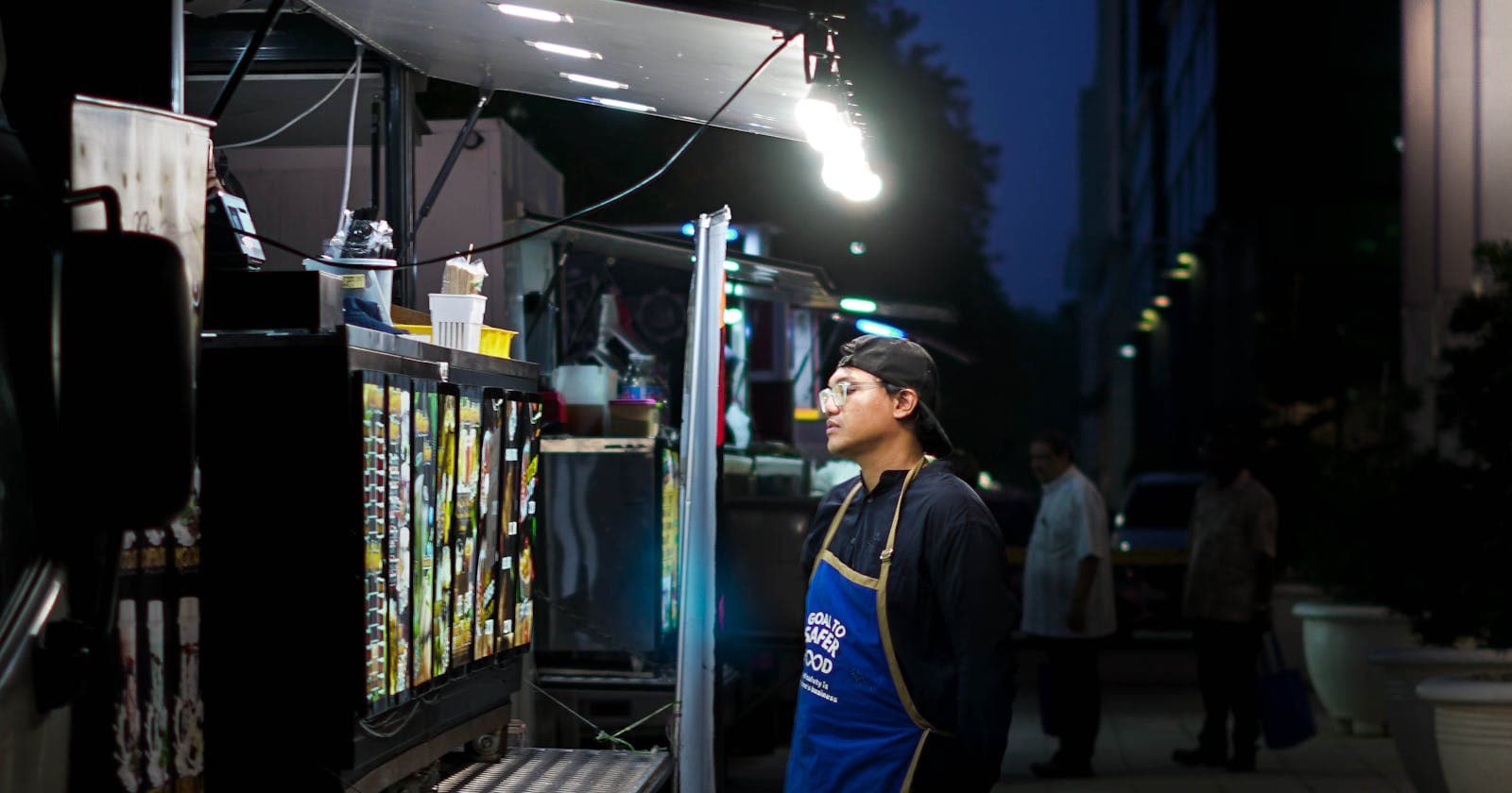 Food truck vendor on a city street at night