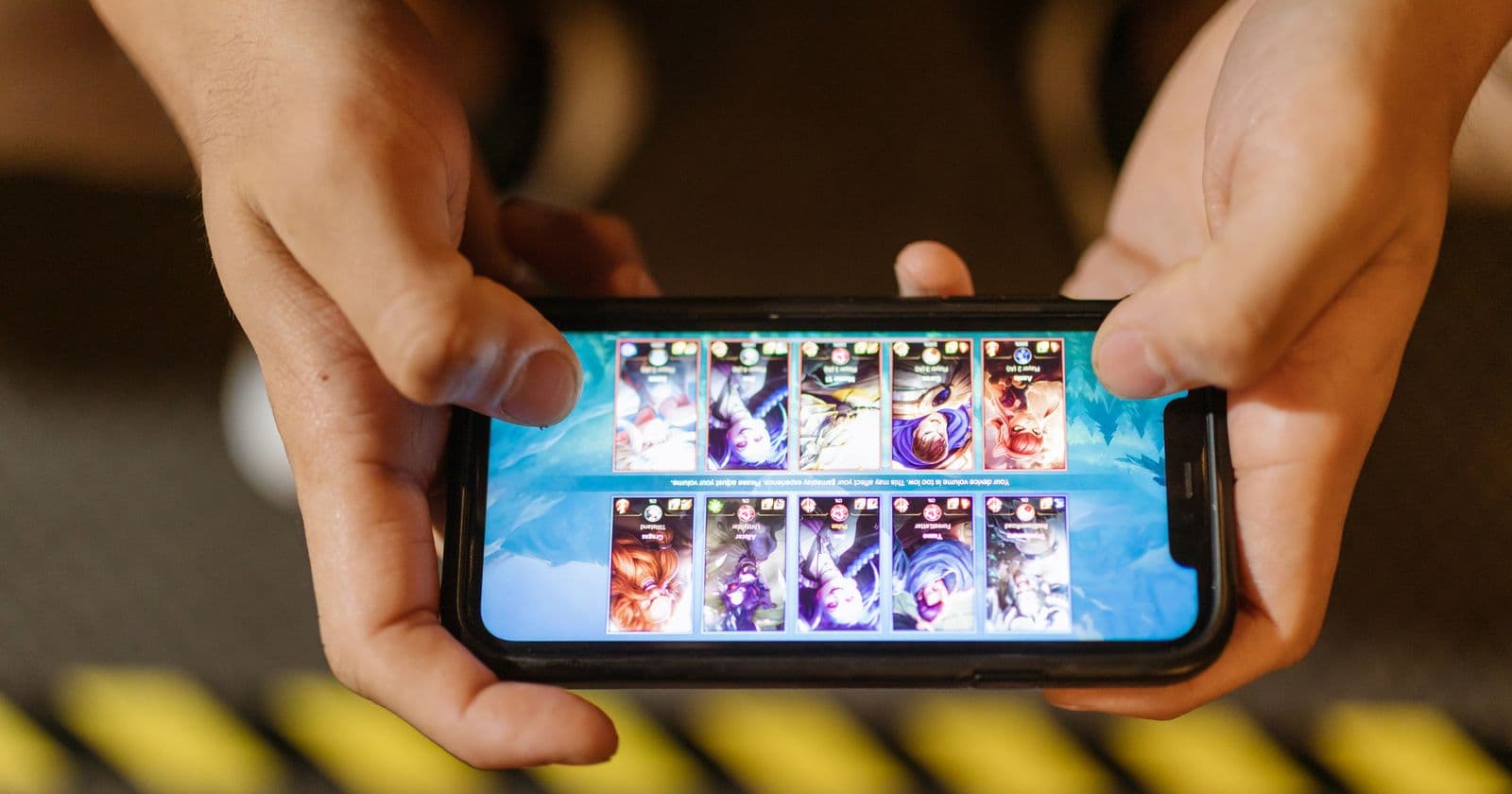 Hands playing a game on a smartphone