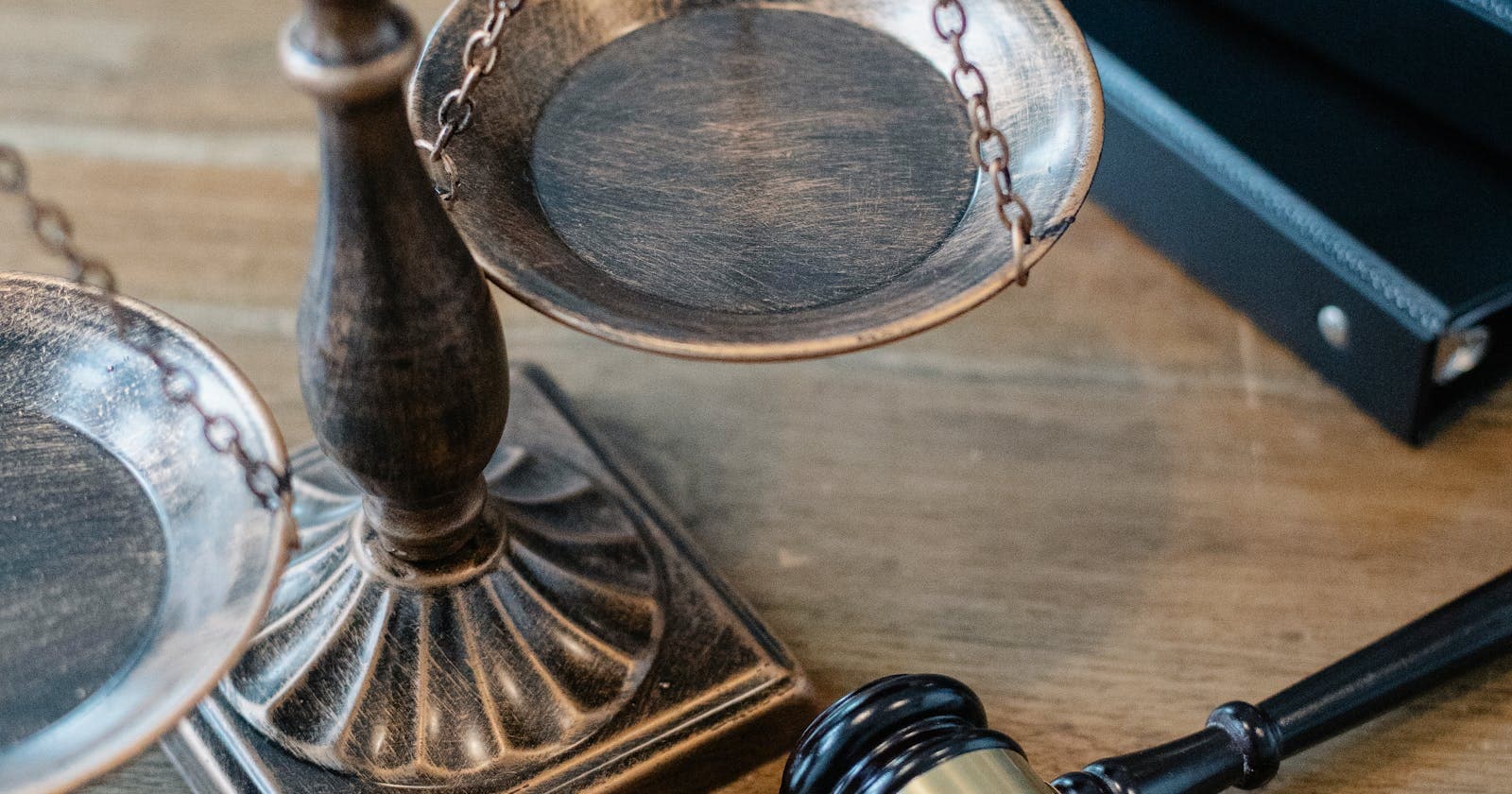 Scales of justice and a gavel on a desk