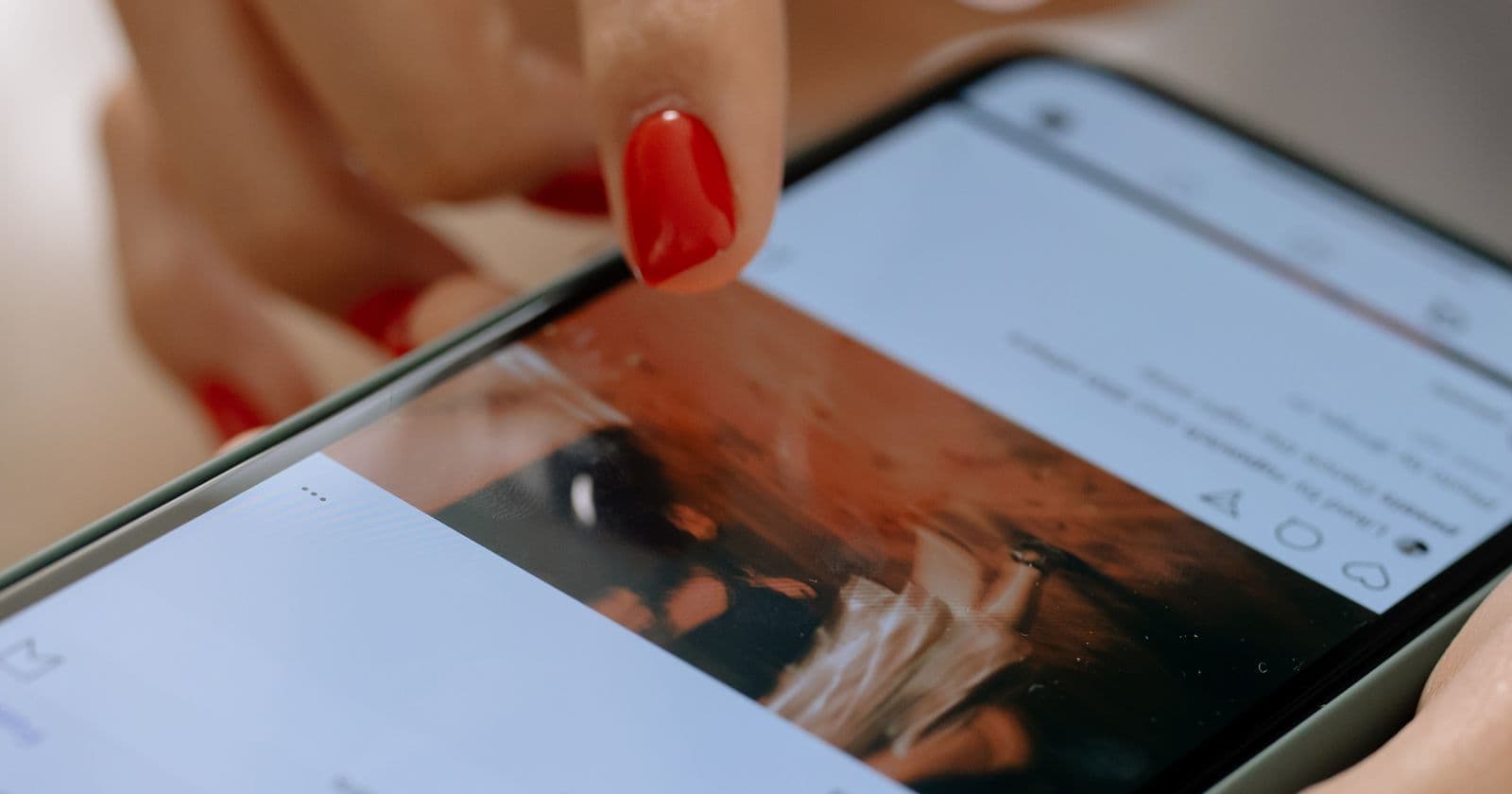 Hand using a social app on a smartphone
