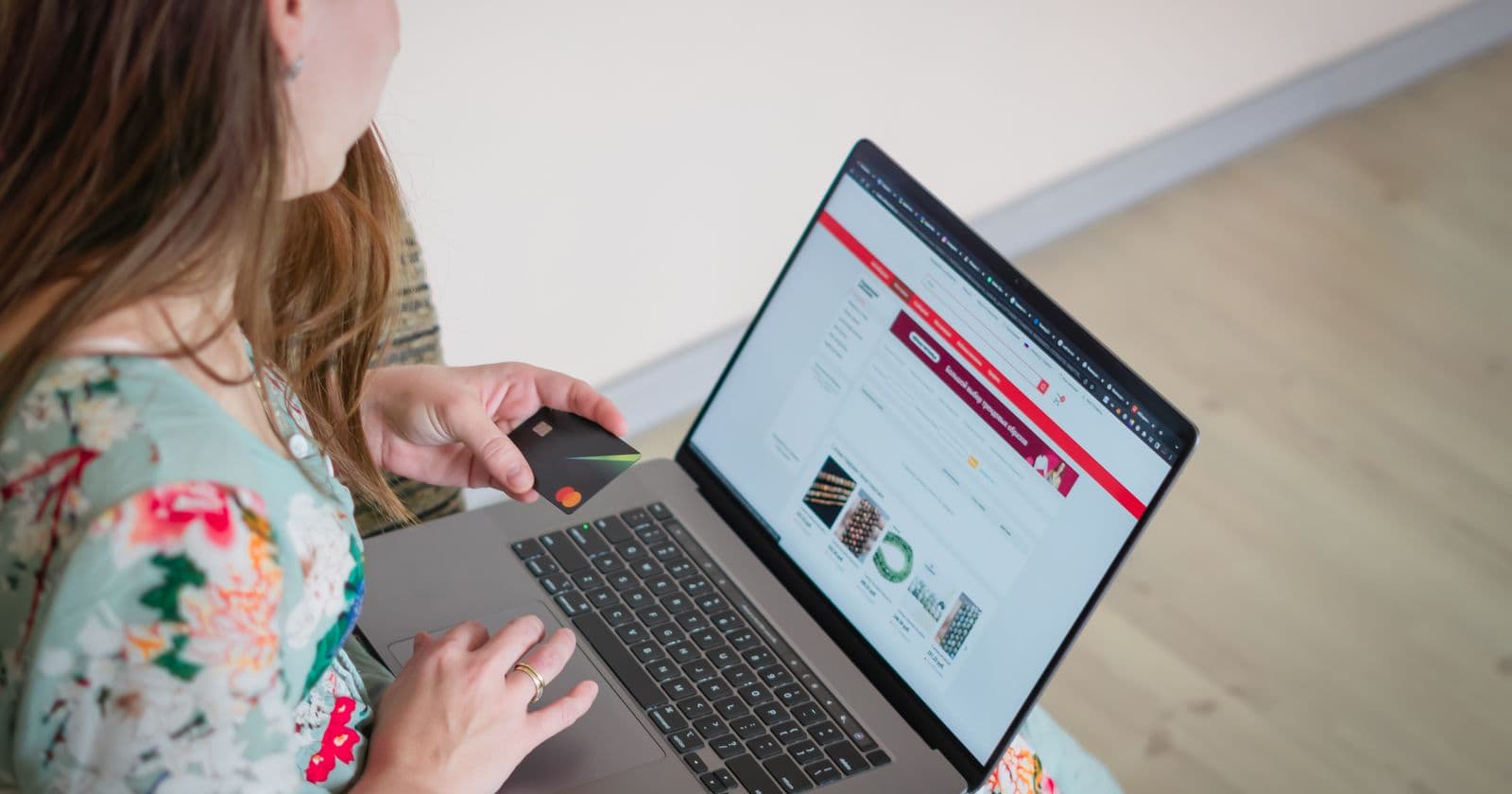 Person shopping online with a laptop and card