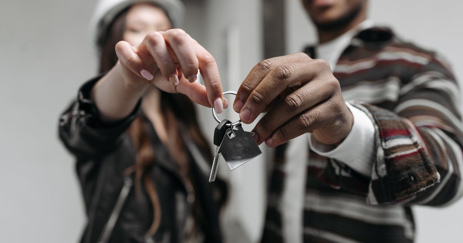Couple holding keys to a new home