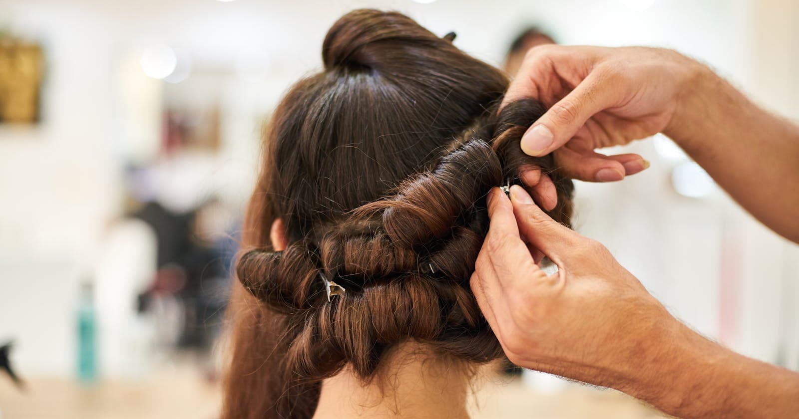 Stylist creating an updo in a hair salon