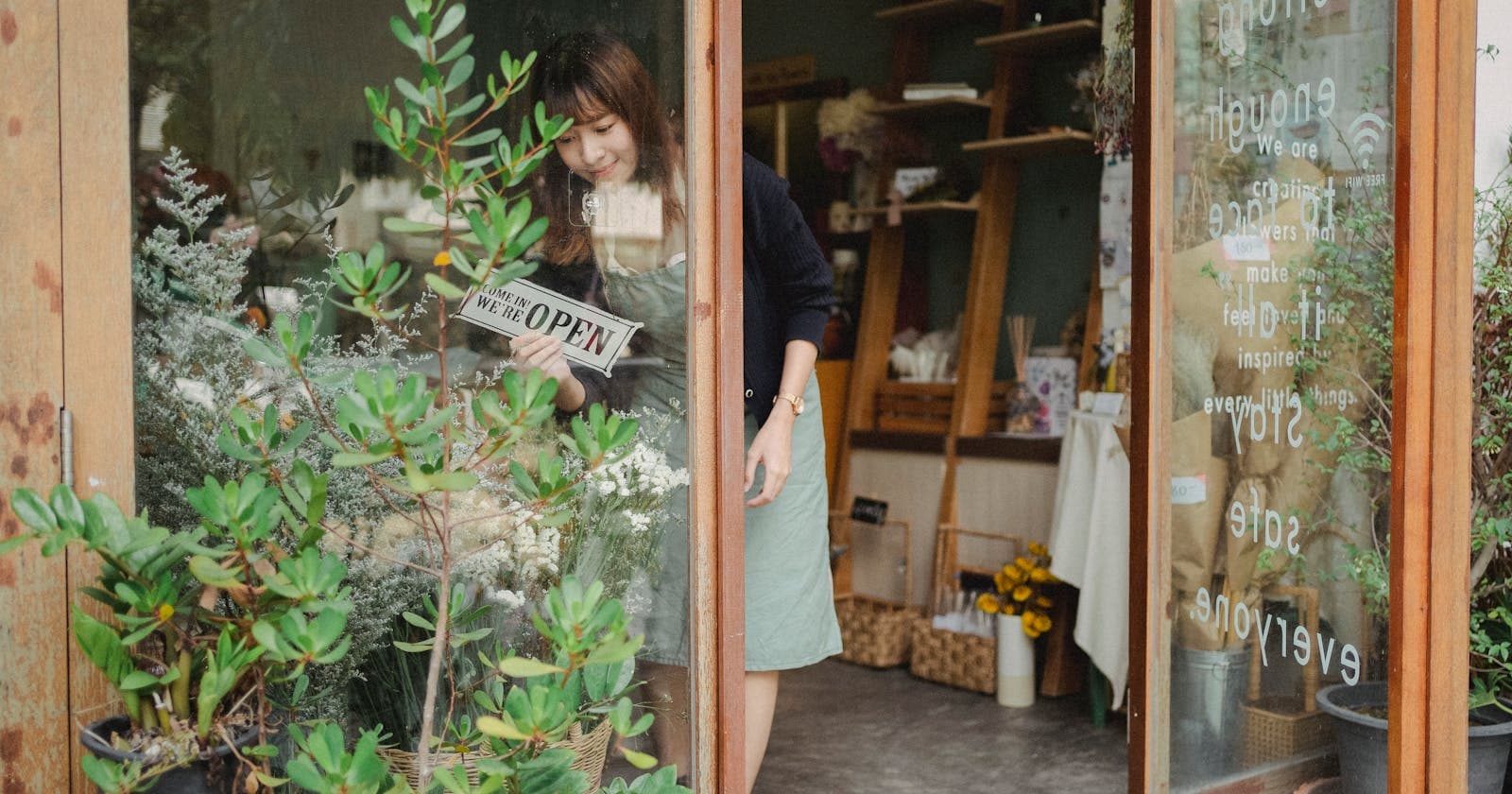Shop owner turning an open sign