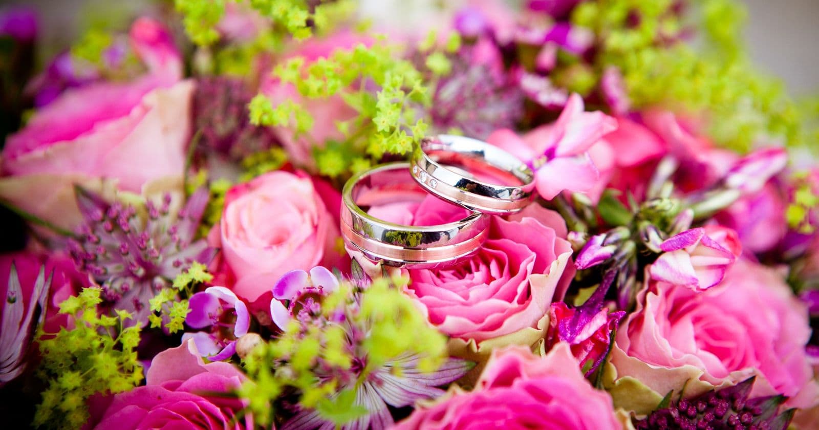 Wedding rings on a floral bouquet